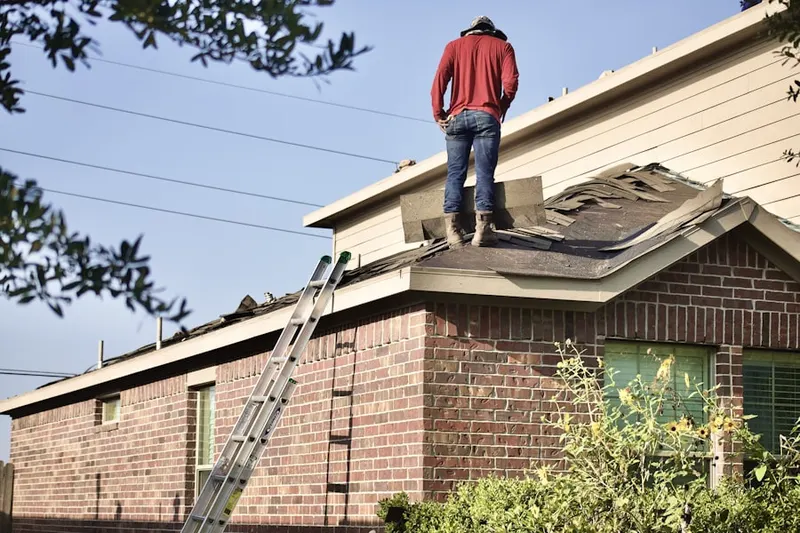 Professional roofer working on a residential roof in Montebello